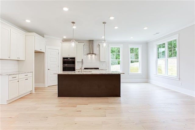 kitchen with decorative backsplash, crown molding, wall chimney exhaust hood, and stainless steel double oven