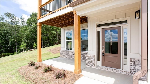 view of exterior entry featuring a yard