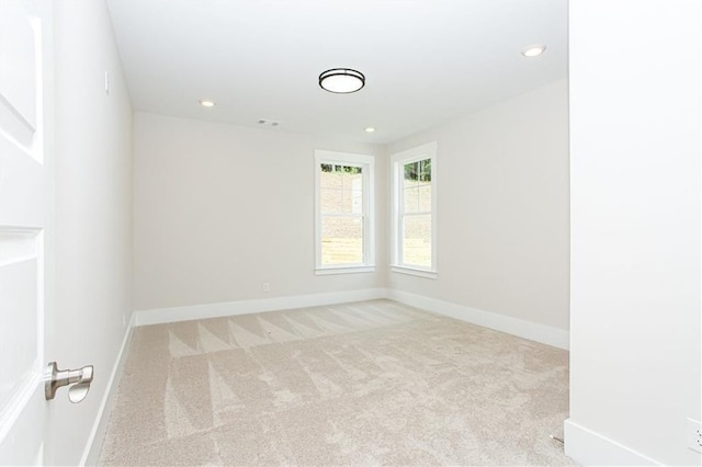 carpeted empty room featuring recessed lighting and baseboards