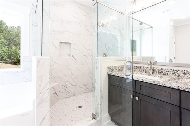 bathroom featuring vanity, visible vents, marble finish floor, and a marble finish shower