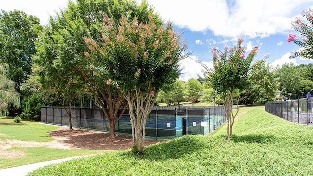 view of pool featuring a tennis court, a yard, and fence