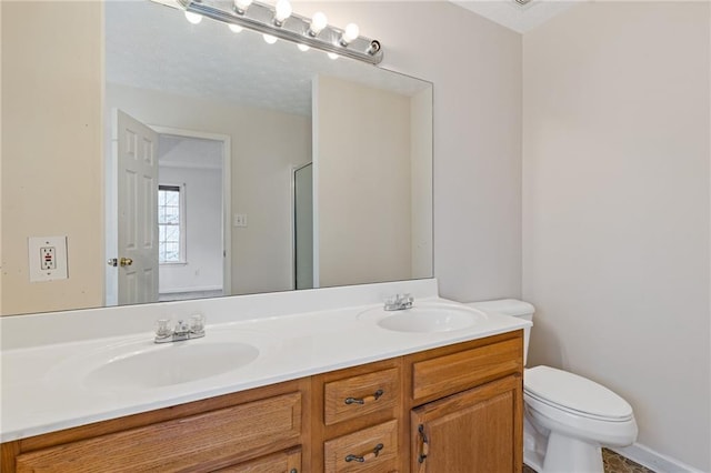 bathroom with vanity, an enclosed shower, and toilet