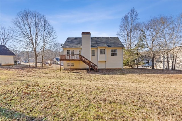 rear view of house featuring a yard and a deck