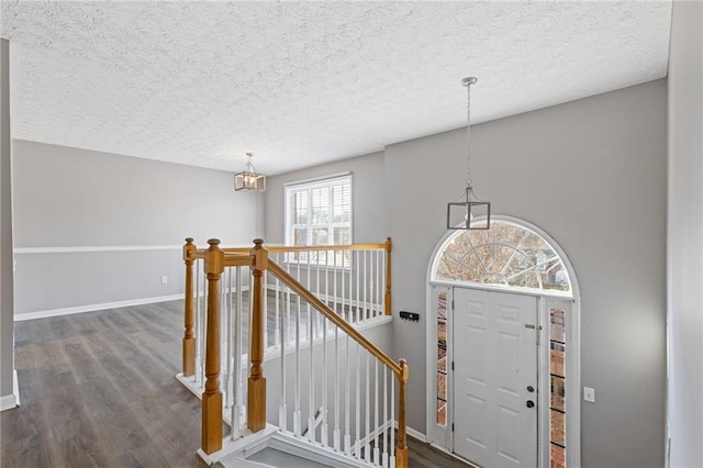 entryway featuring dark hardwood / wood-style flooring and a textured ceiling