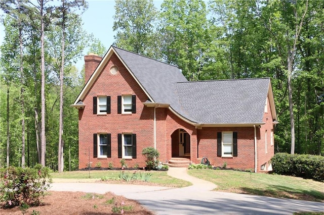 349 Harris Loop, Dallas, GA 30157 - view of front of property featuring a chimney, brick siding, concrete driveway, and roof with shingles