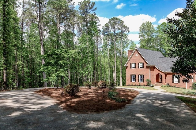 349 Harris Loop, Dallas, GA 30157 - view of front of property featuring asphalt driveway, brick siding, a chimney, and roof with shingles