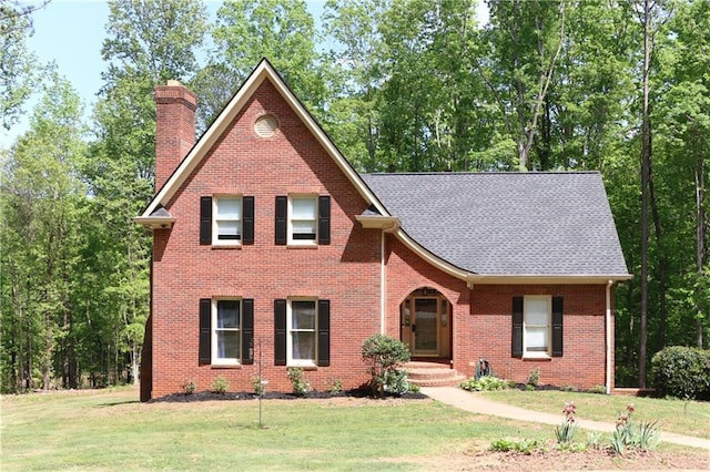 349 Harris Loop, Dallas, GA 30157 - view of front of home featuring a chimney, brick siding, a front yard, and a shingled roof