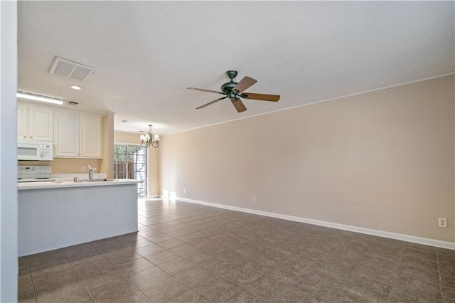 unfurnished living room featuring visible vents, baseboards, dark tile patterned flooring, a sink, and ceiling fan with notable chandelier