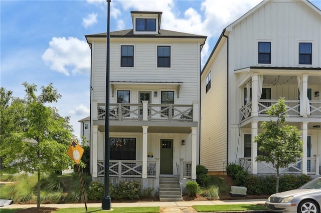 modern farmhouse style home with a balcony and a porch