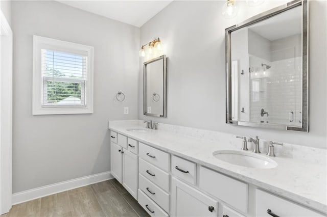 bathroom with double sink vanity and hardwood / wood-style flooring