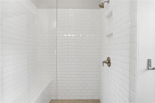 bathroom with tiled shower