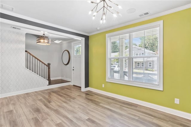 foyer featuring a notable chandelier, light wood-type flooring, and ornamental molding