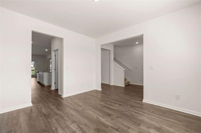 5430 Flat Rock Pt, Stonecrest, GA 30038 - spare room featuring dark wood-style flooring, baseboards, stairway, and recessed lighting