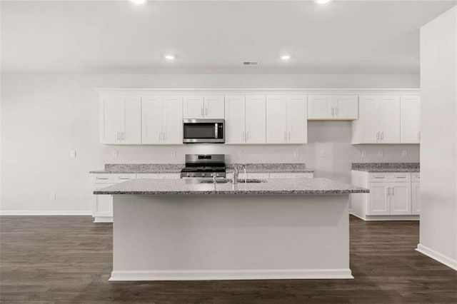 5430 Flat Rock Pt, Stonecrest, GA 30038 - kitchen with appliances with stainless steel finishes, white cabinetry, dark wood-style floors, light stone countertops, and recessed lighting