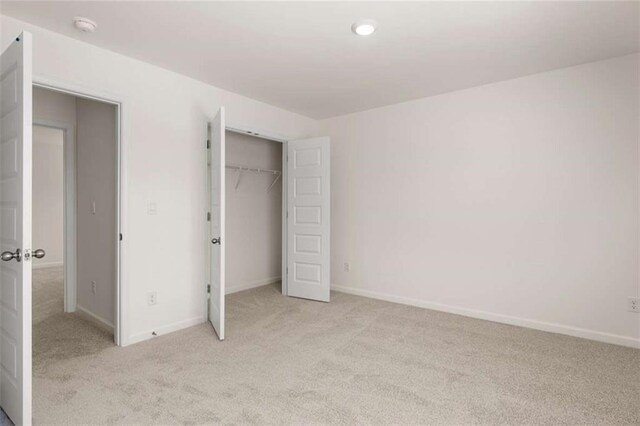 5430 Flat Rock Pt, Stonecrest, GA 30038 - unfurnished bedroom featuring light colored carpet, baseboards, and a closet