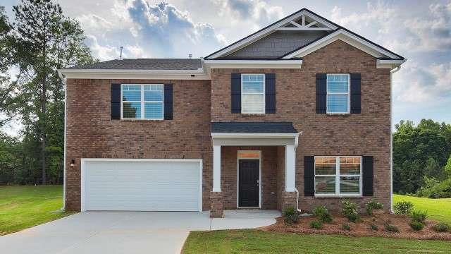 5430 Flat Rock Pt, Stonecrest, GA 30038 - craftsman inspired home featuring an attached garage, concrete driveway, brick siding, and a front yard
