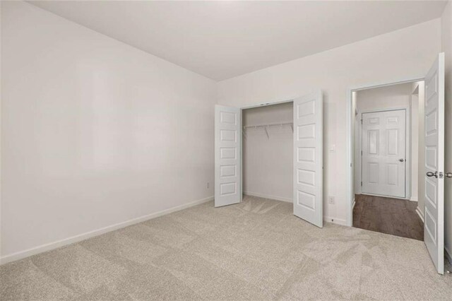 5430 Flat Rock Pt, Stonecrest, GA 30038 - unfurnished bedroom with carpet flooring, baseboards, and a closet