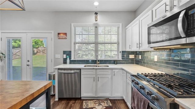 3525 Elder Field Ln, Cumming, GA 30040 - kitchen with appliances with stainless steel finishes, a sink, french doors, light countertops, and tasteful backsplash