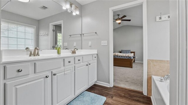 3525 Elder Field Ln, Cumming, GA 30040 - full bath with a ceiling fan, double vanity, a bath, wood finished floors, and ensuite bathroom