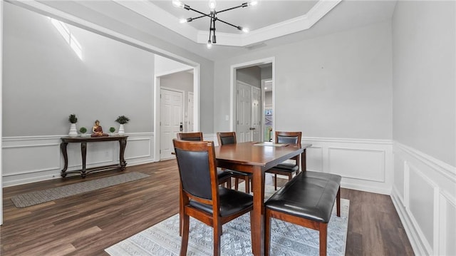 3525 Elder Field Ln, Cumming, GA 30040 - dining space with a chandelier, wood finished floors, a tray ceiling, a decorative wall, and a wainscoted wall