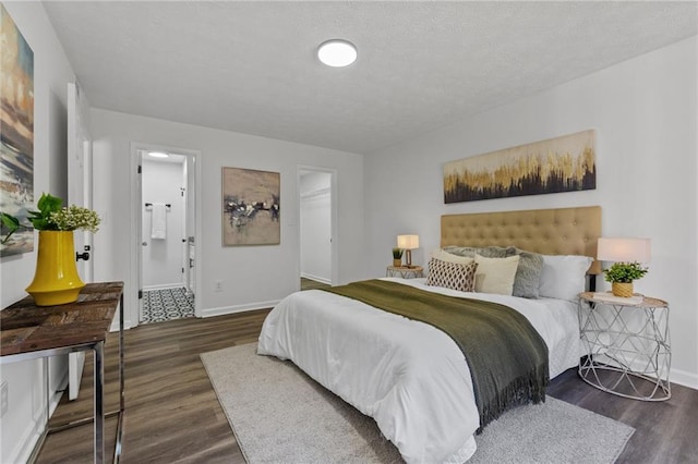 bedroom featuring dark hardwood / wood-style floors, a spacious closet, connected bathroom, and a closet