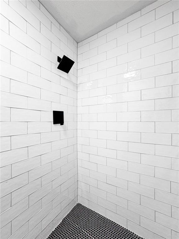 bathroom with tiled shower