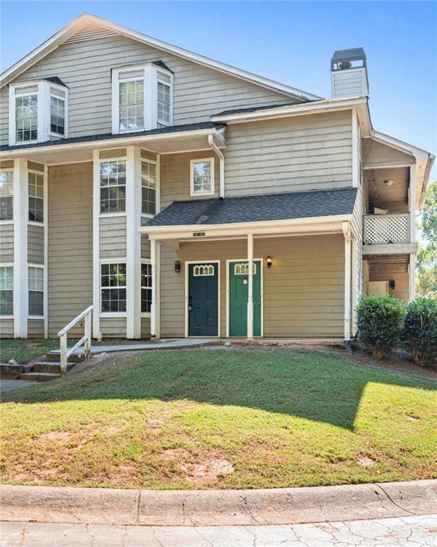 view of front of house with a front lawn and a porch