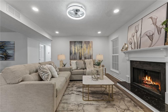 living room with light hardwood / wood-style floors and a premium fireplace