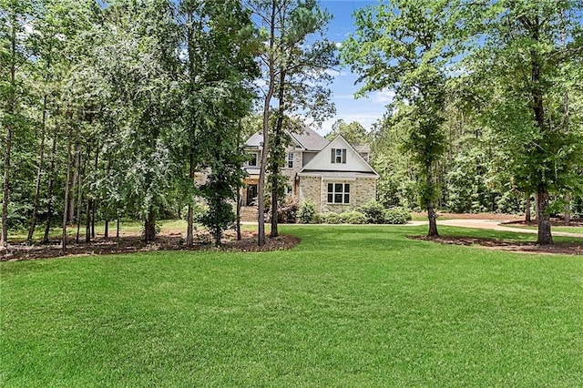 view of front facade with a front lawn and brick siding