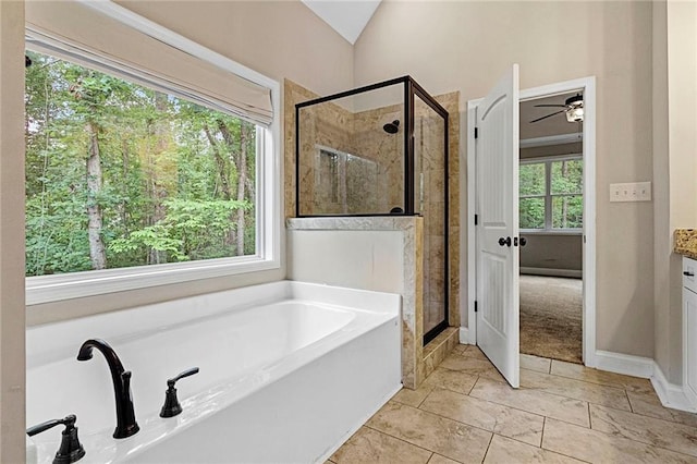 bathroom featuring a garden tub, a shower stall, ceiling fan, lofted ceiling, and vanity