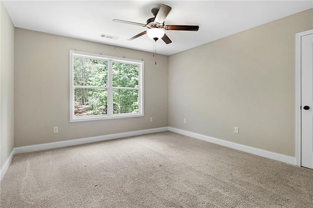 unfurnished room with a ceiling fan, carpet flooring, and baseboards