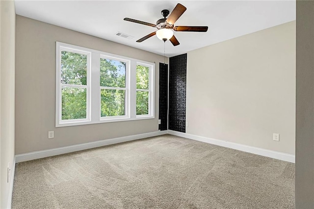 unfurnished room with carpet flooring, ceiling fan, and baseboards