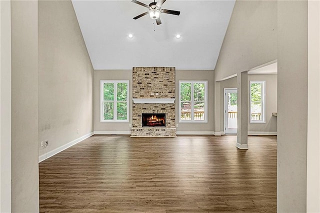 unfurnished living room featuring plenty of natural light, dark wood-style floors, a ceiling fan, baseboards, and recessed lighting
