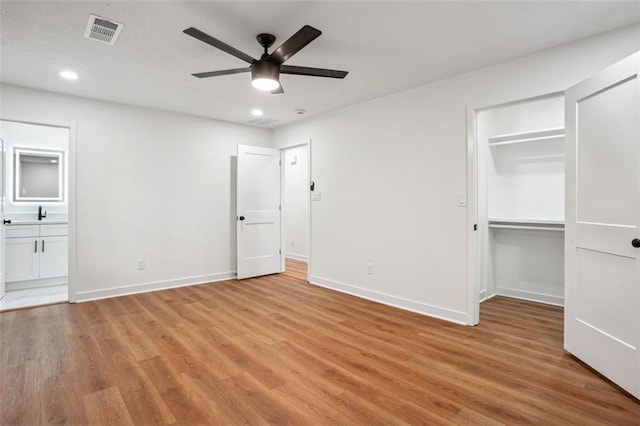 unfurnished bedroom featuring visible vents, baseboards, and light wood-type flooring