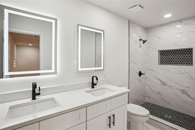 full bath featuring a marble finish shower, marble finish floor, and a sink