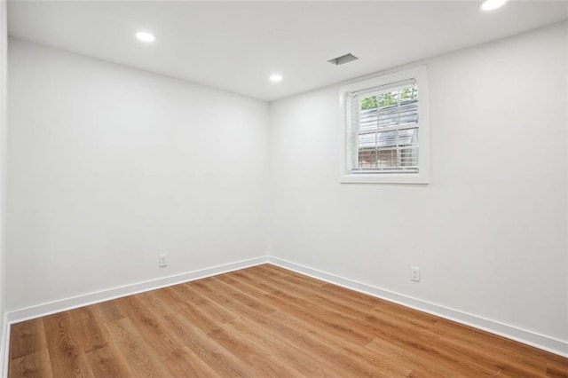 unfurnished room featuring recessed lighting, light wood finished floors, and baseboards