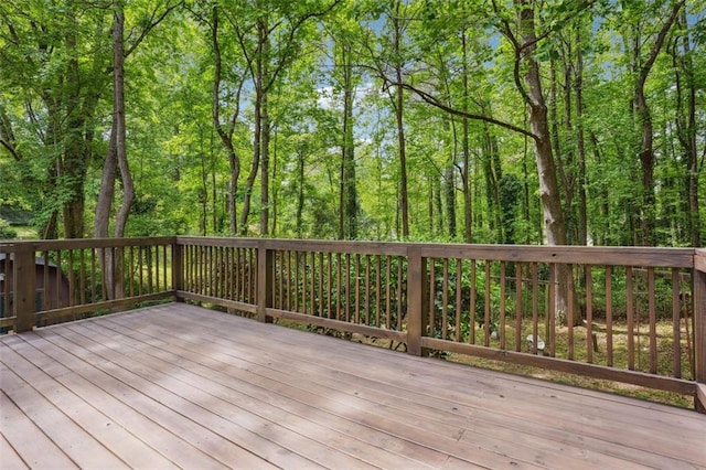wooden terrace with a view of trees