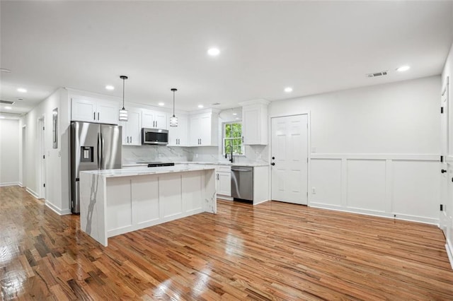 kitchen with white cabinetry, visible vents, appliances with stainless steel finishes, and light wood-type flooring