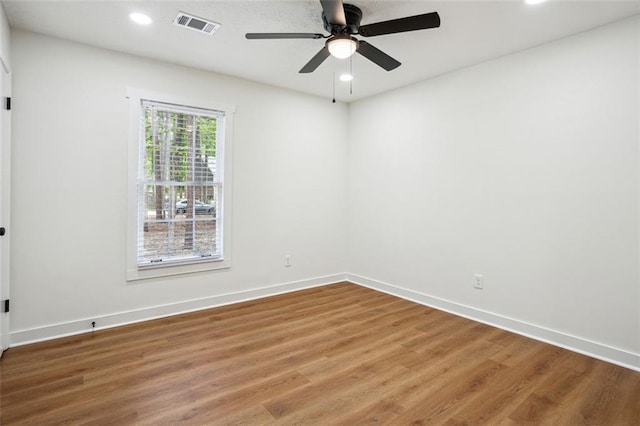 empty room with recessed lighting, wood finished floors, ceiling fan, baseboards, and visible vents