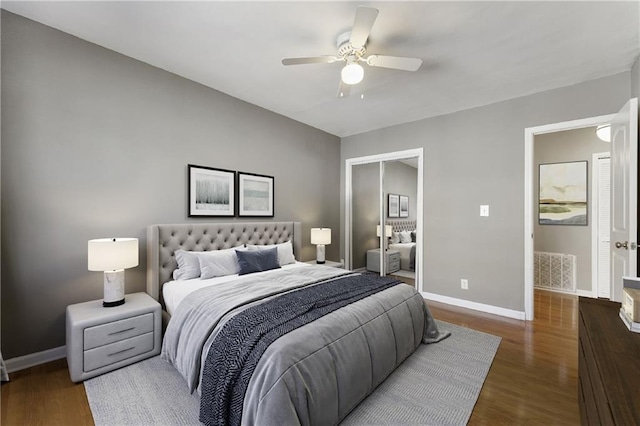 bedroom with dark hardwood / wood-style flooring and ceiling fan