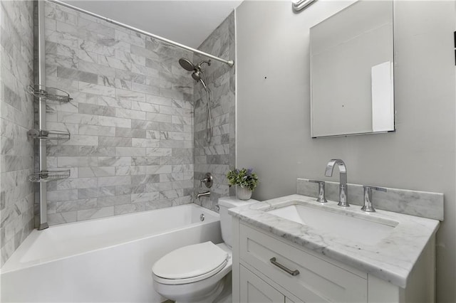 full bathroom featuring vanity, tiled shower / bath, and toilet