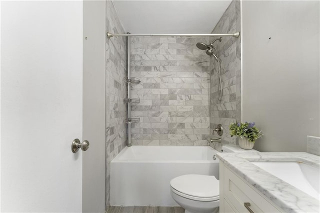 full bathroom with tiled shower / bath combo, vanity, and toilet