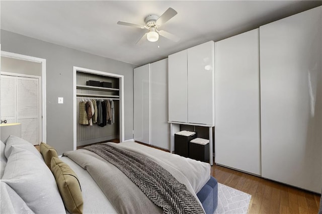 bedroom featuring ceiling fan, light hardwood / wood-style floors, and a closet