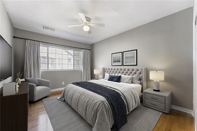 bedroom with hardwood / wood-style flooring and ceiling fan