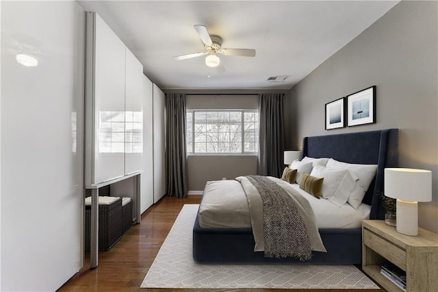 bedroom featuring dark hardwood / wood-style flooring and ceiling fan