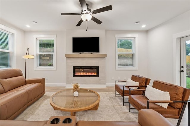 2445 Hidden Creek Rd, Kennesaw, GA 30152 - living room featuring a tiled fireplace, light wood finished floors, ceiling fan, plenty of natural light, and recessed lighting