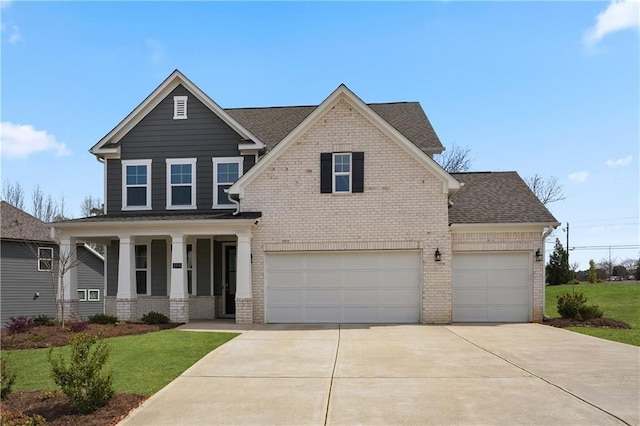 view of front of property featuring a garage, a front lawn, and a porch