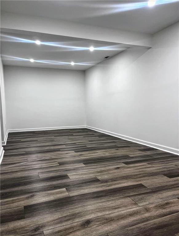 empty room with dark wood-type flooring