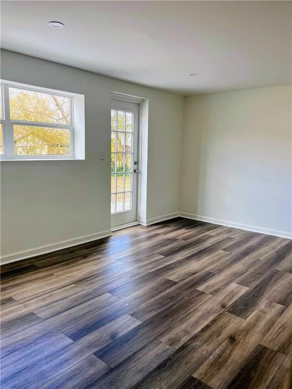 unfurnished room featuring dark hardwood / wood-style floors