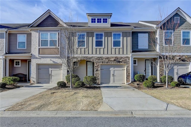 townhome / multi-family property featuring driveway, a garage, and board and batten siding